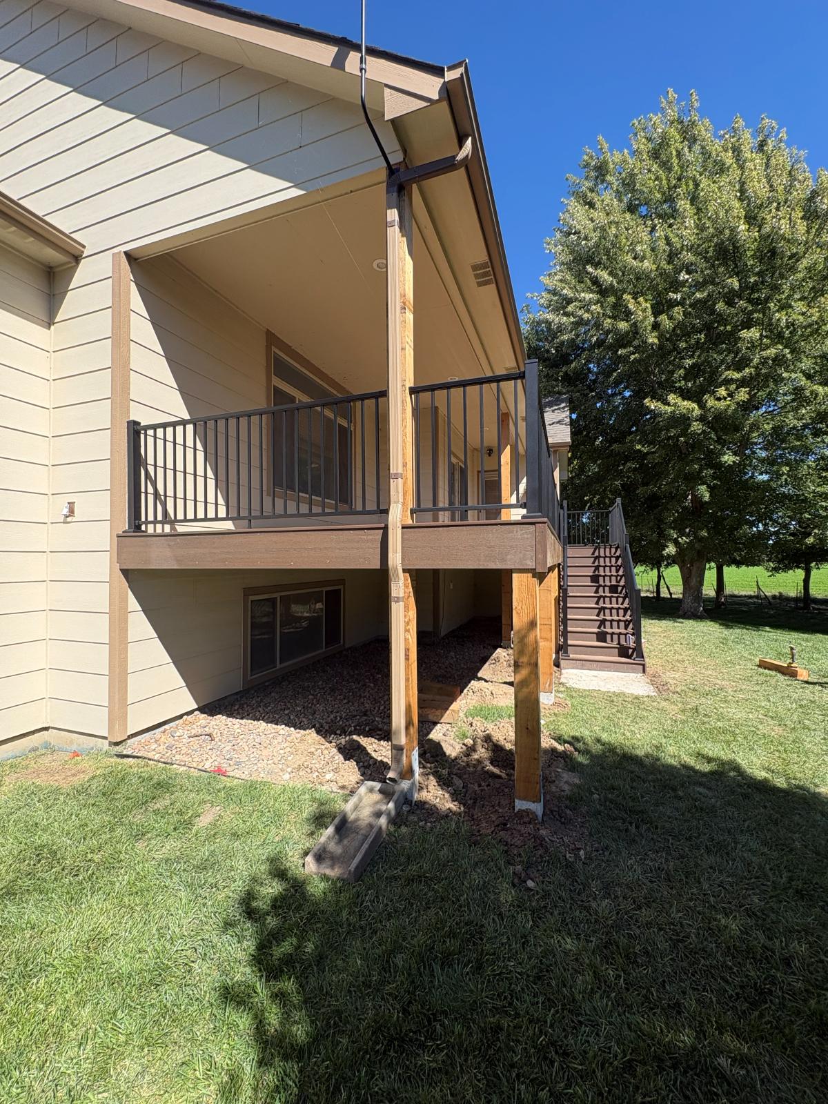Side view of an elevated deck showing the cedar support posts and footings