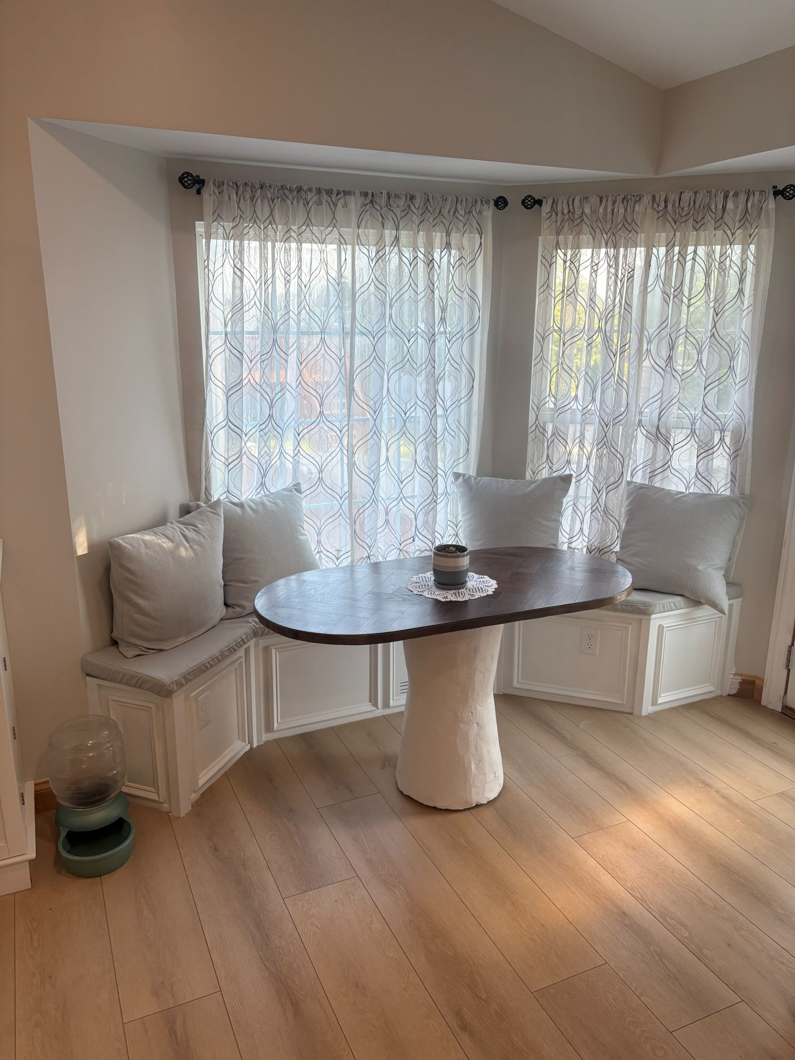 Built-in banquette bench seating in a bay window breakfast nook