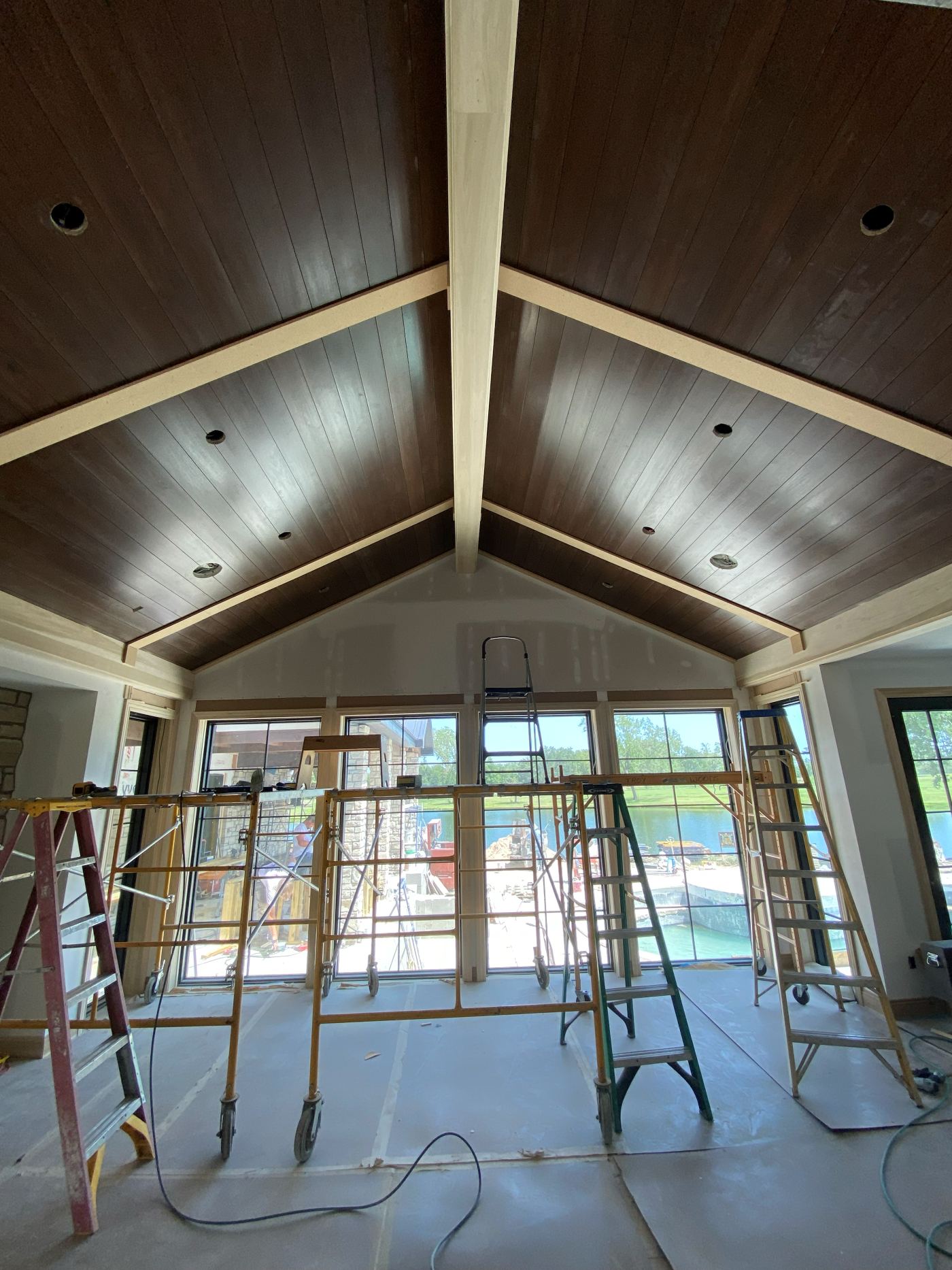 Stained tongue-and-groove vaulted ceiling with exposed beams